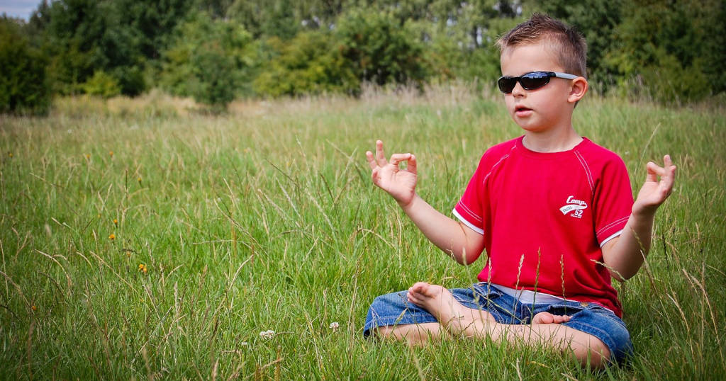 Zen boy relaxing because he uses a managed wordpress hosting provider and has peace of mind